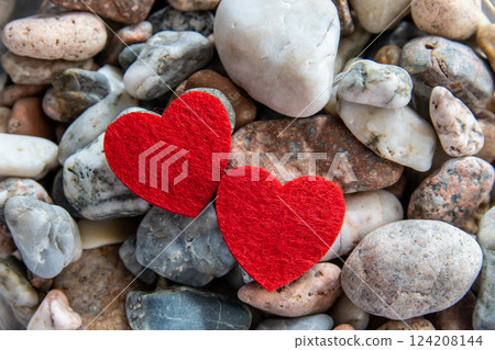 Two red hearts made of material fabric on the black background. Concept of Valentine's day and romantic love. 124208144