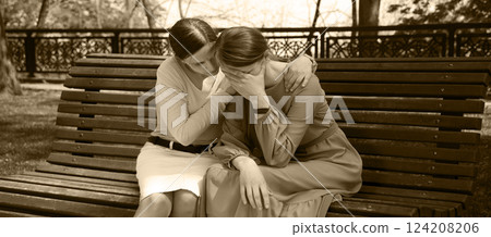 Two girls comfort one another 124208206