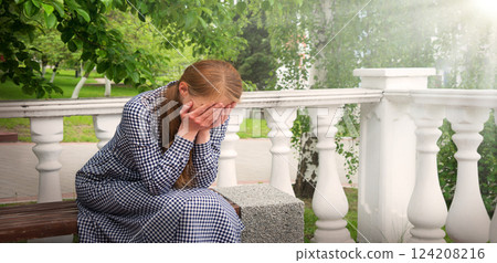 Crying woman in the park 124208216