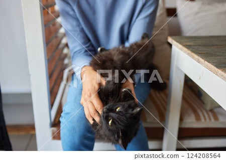 young man holding and petting cute cat male young man holding and petting cute cat male 124208564