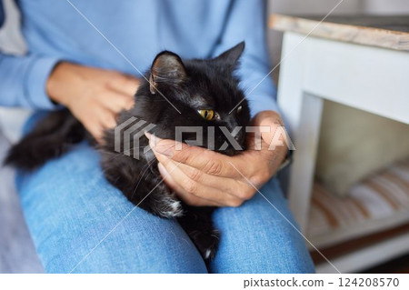 young man holding and petting cute cat male young man holding and petting cute cat male 124208570