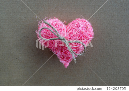 Heart of pink material fabric with bow on a rustic natural background with copyspace. Concept of Valentine's day and romantic love. Heart of pink material fabric with bow on a rustic natural background with copyspace. Concept of Valentine's day and romantic love. 124208705