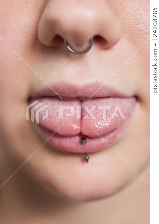 tongue splitting. cutting the tongue, one type of modification of the human body. surgery concept. tongue splitting. cutting the tongue, one type of modification of the human body. surgery concept. 124208785
