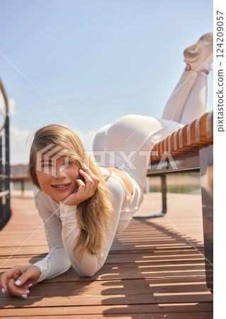 Portrait of fit and sporty young woman doing stretching in city. 124209057