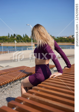 Portrait of fit and sporty young woman doing stretching in city. Portrait of fit and sporty young woman doing stretching in city. 124209093