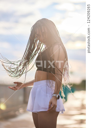 Happy successful sportswoman raising arms to the sky on golden back lighting sunset summer. Happy successful sportswoman raising arms to the sky on golden back lighting sunset summer. 124209265