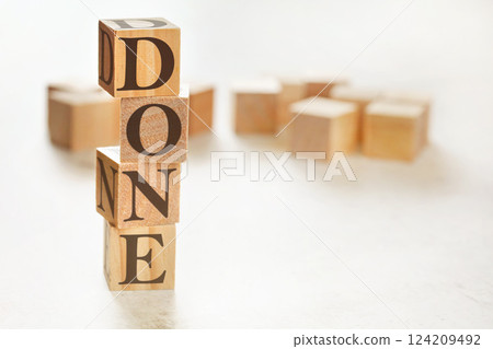 Four wooden cubes arranged in stack with word DONE on them, space for text / image at down right corner Four wooden cubes arranged in stack with word DONE on them, space for text / image at down right corner 124209492
