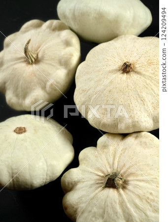 White pattypan squash pumpkins on black board 124209494