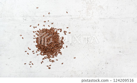 Flax seeds on white stone like board, view from above, banner with space for text right side 124209516