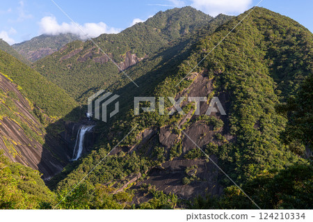 Majestic mountains and Chihiro Falls on a clear autumn day in Yakushima National Park 124210334