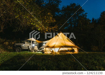 Tent with lights on, campsite at night 124211130