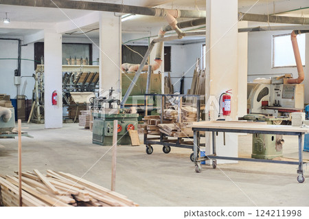 Interior of Wood Processing Industry Featuring CNC Cutting Machines and Wood Processing Equipment Interior of Wood Processing Industry Featuring CNC Cutting Machines and Wood Processing Equipment 124211998