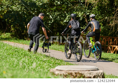 A professional videographer skillfully captures the joyous journey of a couple on bicycles through the park, blending cinematic expertise with the natural allure of outdoor adventure 124212044