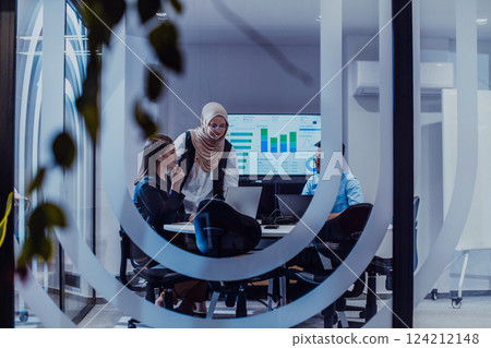 A diverse group of businessmen collaborates and tests a new virtual reality technology, wearing virtual glasses, showcasing innovation and creativity in their futuristic workspace 124212148