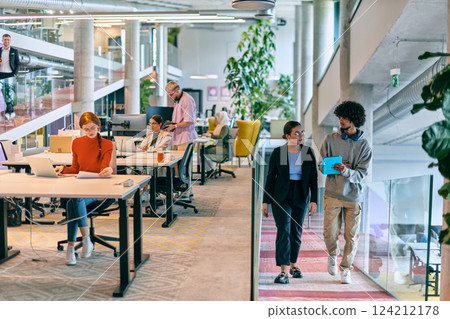 In a modern startup office, a diverse group of young professionals collaboratively tackles various business problems and challenges, surrounded by their engaged colleagues, fostering innovation and 124212178