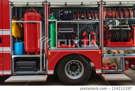 A state-of-the-art firetruck, equipped with advanced rescue technology, stands ready with its skilled firefighting team, prepared to intervene and respond rapidly to emergencies, ensuring the safety A state-of-the-art firetruck, equipped with advanced rescue technology, stands ready with its skilled firefighting team, prepared to intervene and respond rapidly to emergencies, ensuring the safety 124212197