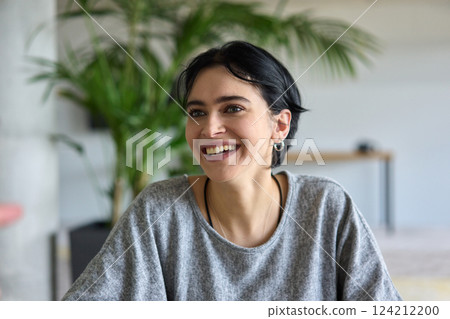 A close up portrait of a young businesswoman engaged in a professional meeting, confidently discussing ideas and strategies with her colleagues 124212200