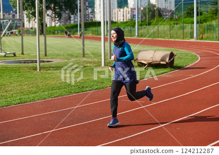 A muslim woman in a burqa sports muslim clothes running on a marathon course and preparing for upcoming competitions A muslim woman in a burqa sports muslim clothes running on a marathon course and preparing for upcoming competitions 124212287