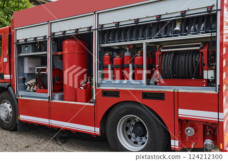 A state-of-the-art firetruck, equipped with advanced rescue technology, stands ready with its skilled firefighting team, prepared to intervene and respond rapidly to emergencies, ensuring the safety A state-of-the-art firetruck, equipped with advanced rescue technology, stands ready with its skilled firefighting team, prepared to intervene and respond rapidly to emergencies, ensuring the safety 124212300