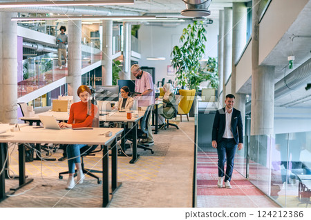 In a modern startup office, a diverse group of young professionals collaboratively tackles various business problems and challenges, surrounded by their engaged colleagues, fostering innovation and 124212386
