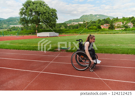 A woman with disablity driving a wheelchair on a track while preparing for the Paralympic Games 124212425