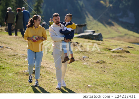 A modern family, along with their son, revels in the joy of a muddy day in nature, running and playing together, encapsulating the beauty of a healthy and active lifestyle A modern family, along with their son, revels in the joy of a muddy day in nature, running and playing together, encapsulating the beauty of a healthy and active lifestyle 124212431