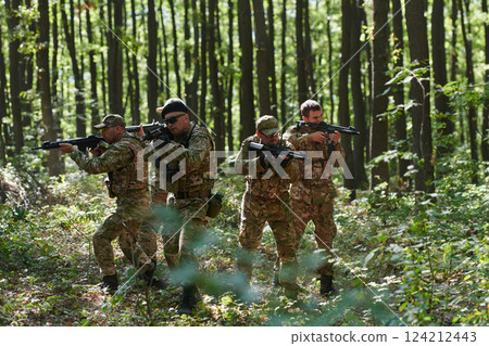 A specialized military antiterrorist unit conducts a covert operation in dense, hazardous woodland, demonstrating precision, discipline, and strategic readiness 124212443