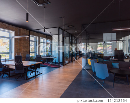 In a setting of modern, glass-walled business startup offices, the open, airy workspace reflects a contemporary and innovative ambiance, promising a dynamic environment for entrepreneurial growth 124212564