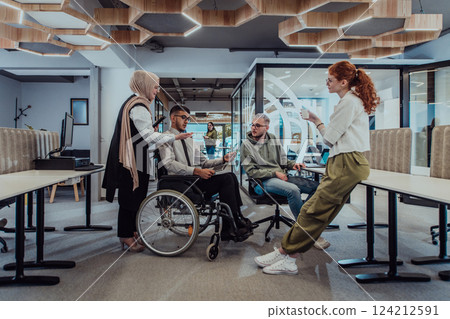 Young group of business people brainstorming together in a startup space, discussing business projects, investments, and solving challenges. 124212591