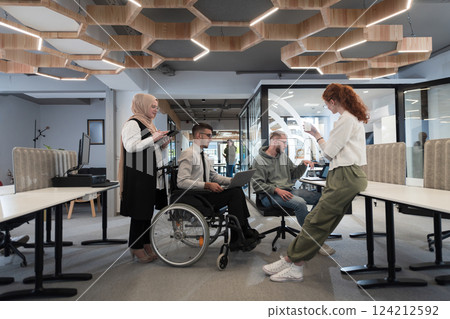 Young group of business people brainstorming together in a startup space, discussing business projects, investments, and solving challenges. Young group of business people brainstorming together in a startup space, discussing business projects, investments, and solving challenges. 124212592