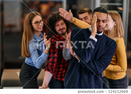 A group of young business people have fun playing interesting games while taking a break from work in a modern office. Selective focus A group of young business people have fun playing interesting games while taking a break from work in a modern office. Selective focus 124212609