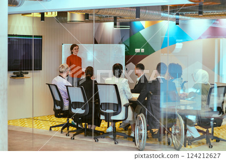 A pregnant business woman with orange hair confidently presents her business plan to colleagues in a modern glass office, embodying entrepreneurship and innovation 124212627