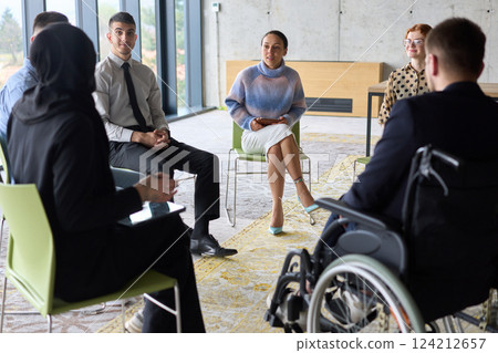 Corporate business team meeting with a manager or coach. Group of happy diverse, multiracial people sitting in a circle  124212657