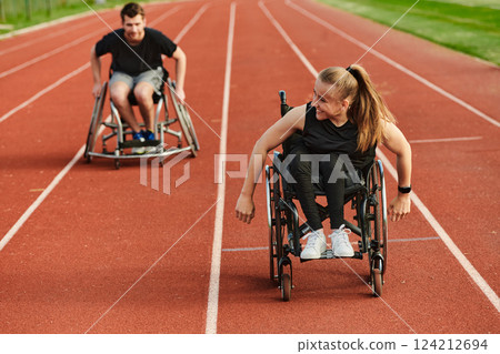 An inspiring couple with disability showcase their incredible determination and strength as they train together for the Paralympics pushing their wheelchairs in marathon track An inspiring couple with disability showcase their incredible determination and strength as they train together for the Paralympics pushing their wheelchairs in marathon track 124212694