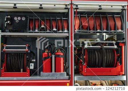 Close-up of essential firefighting equipment on a modern firetruck, showcasing tools and gear ready for emergency response to hazardous fire situations Close-up of essential firefighting equipment on a modern firetruck, showcasing tools and gear ready for emergency response to hazardous fire situations 124212710