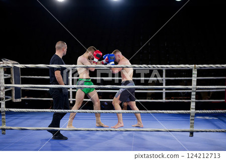 Fierce boxing match showcases athletes' power and skill. 124212713