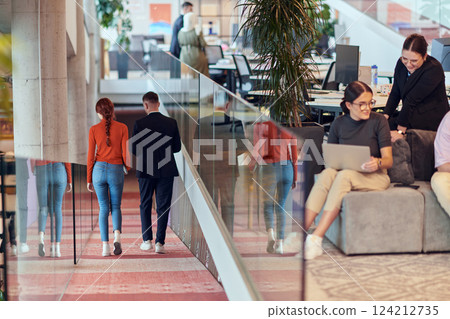 In a modern startup office, a diverse group of young professionals collaboratively tackles various business problems and challenges, surrounded by their engaged colleagues, fostering innovation and 124212735