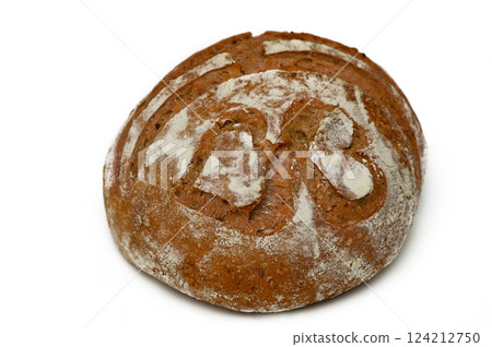 Freshly baked artisanal bread with unique design resting on clean surface Freshly baked artisanal bread with unique design resting on clean surface 124212750