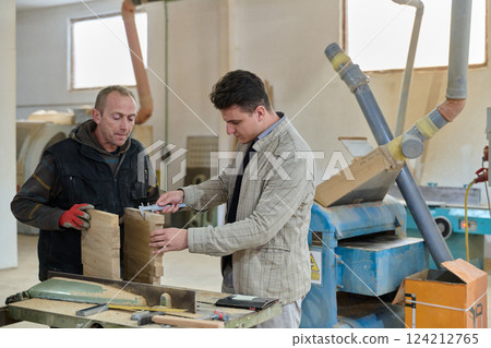 Production Manager Demonstrating Woodcraft Techniques to Employee for Decorative and Residential Items Production Manager Demonstrating Woodcraft Techniques to Employee for Decorative and Residential Items 124212765