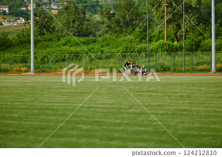 A cameraman filming the participants of the Paralympic race on the marathon course 124212810