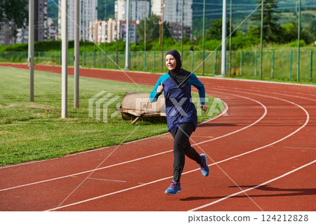 A muslim woman in a burqa sports muslim clothes running on a marathon course and preparing for upcoming competitions 124212828