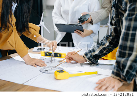Creative architect projecting on the big drawings with architectural project at construction site 124212981