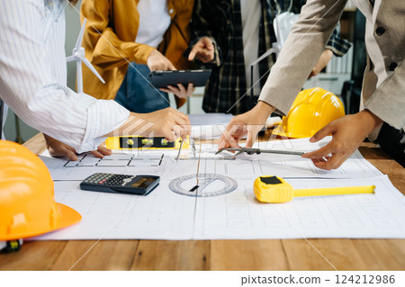 Creative architect projecting on the big drawings with architectural project Creative architect projecting on the big drawings with architectural project 124212986