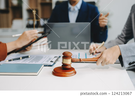 business people and lawyers discussing contract papers sitting at the table. Concepts of law, advice, legal services. business people and lawyers discussing contract papers sitting at the table. Concepts of law, advice, legal services. 124213067