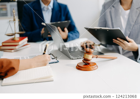 business people and lawyers discussing contract papers sitting at the table. Concepts of law, advice, legal services. business people and lawyers discussing contract papers sitting at the table. Concepts of law, advice, legal services. 124213068