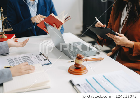 business people and lawyers discussing contract papers sitting at the table. Concepts of law, advice, legal services. 124213072