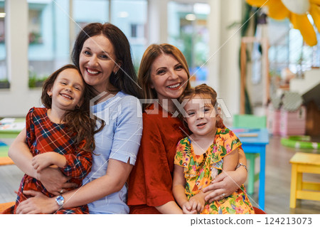 A child hugging a teacher in a modern kindergarten A child hugging a teacher in a modern kindergarten 124213073