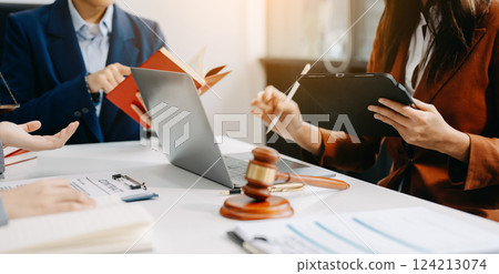 business people and lawyers discussing contract papers sitting at the table. Concepts of law, advice, legal services. business people and lawyers discussing contract papers sitting at the table. Concepts of law, advice, legal services. 124213074