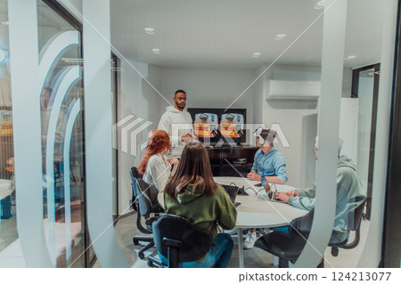 A diverse group of businessmen collaborates and tests a new virtual reality technology, wearing virtual glasses, showcasing innovation and creativity in their futuristic workspace 124213077