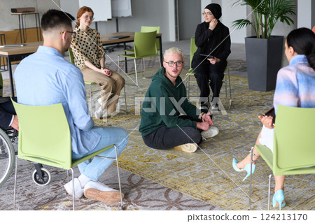 Corporate business team meeting with a manager or coach. Group of happy diverse, multiracial people sitting in a circle Corporate business team meeting with a manager or coach. Group of happy diverse, multiracial people sitting in a circle 124213170